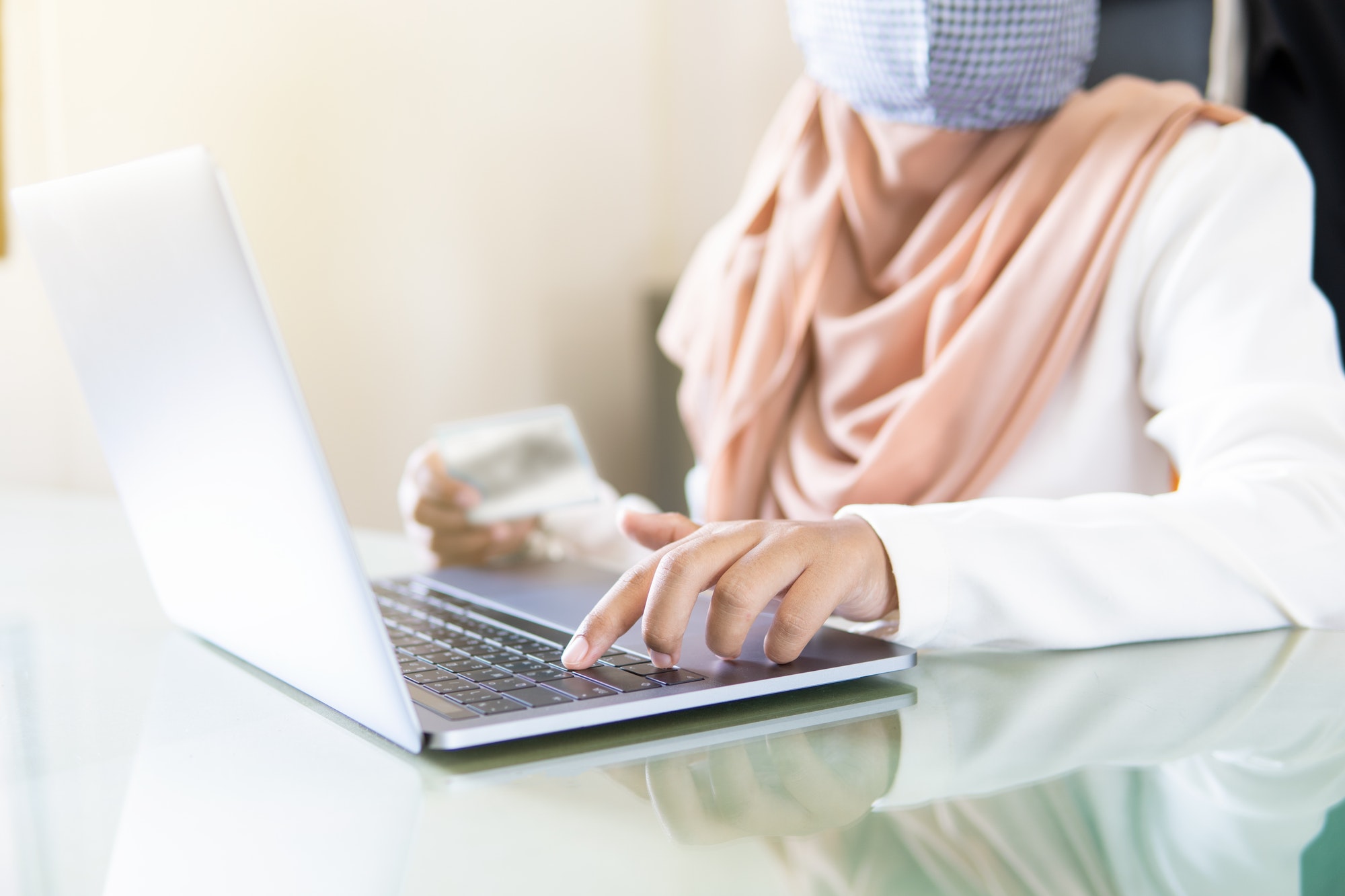 Hand business muslin women typing on laptop and credit card for payment online